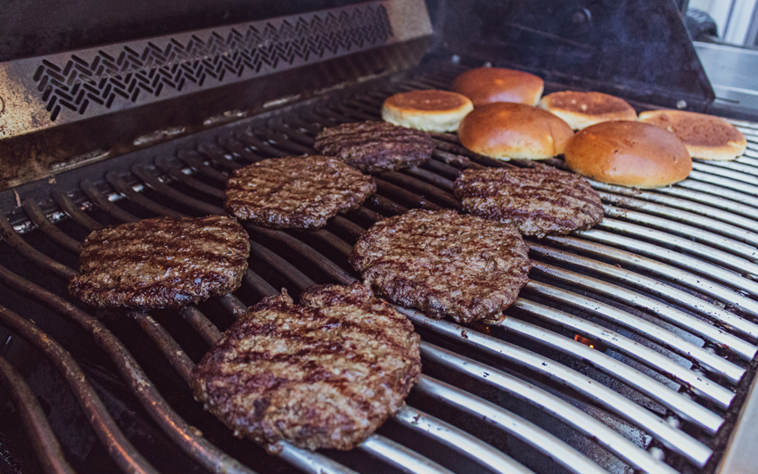 Wagyu burgers from the recipe cooking on the grill